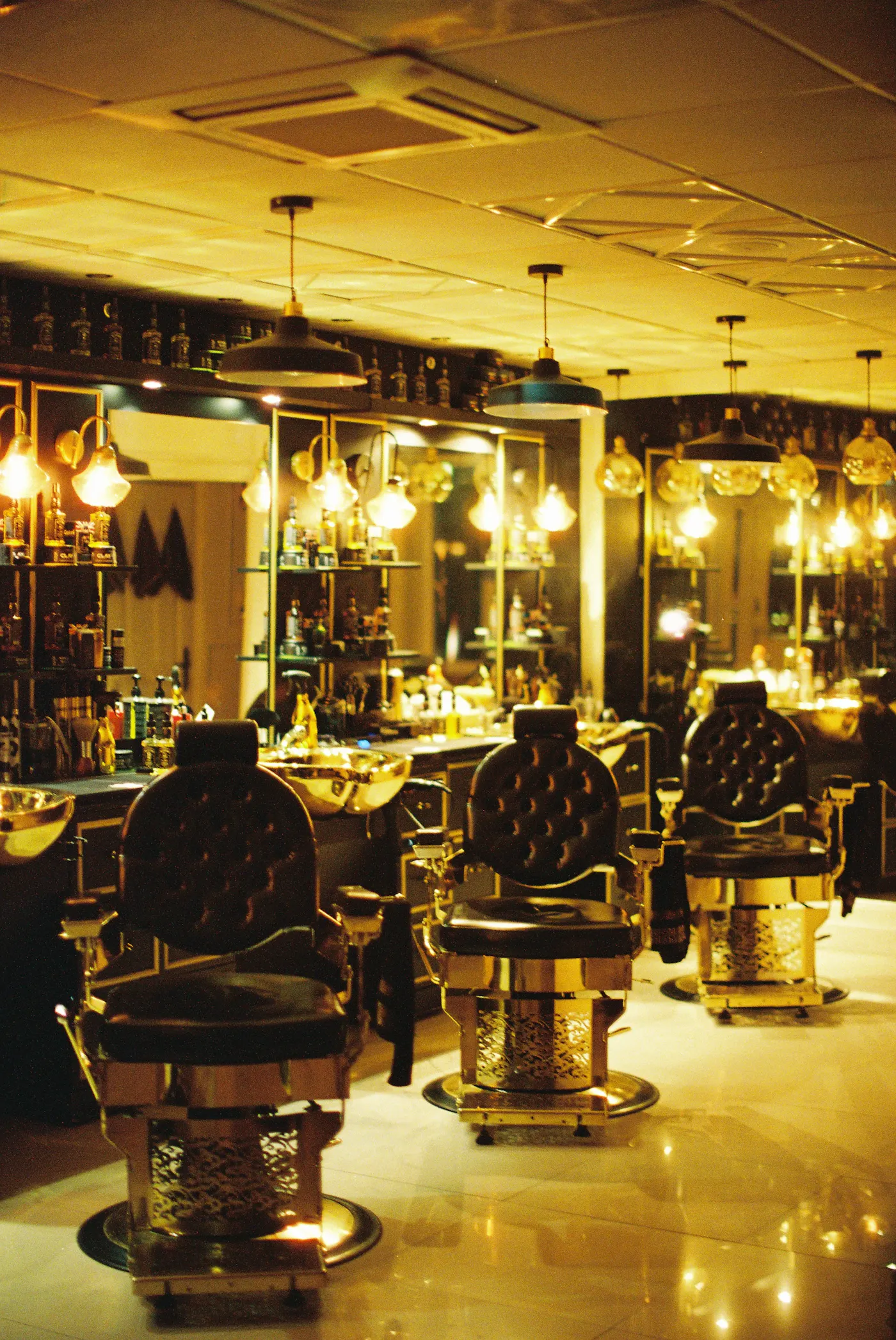 The lounge — gold-lit styling chairs
